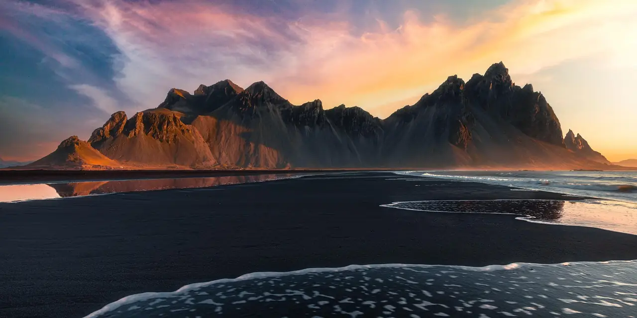 Le mont Vestrahorn et la plage de sable noir de Stokksnes au coucher du soleil, en Islande